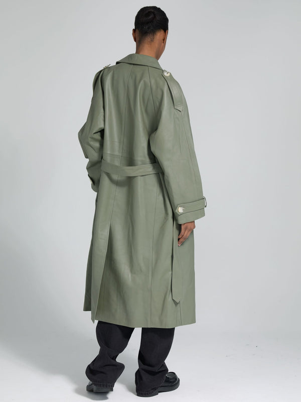 A model showcases a stylish olive green trench coat from MEOTINE, featuring a belted waist and shoulder epaulets, viewed from the back.