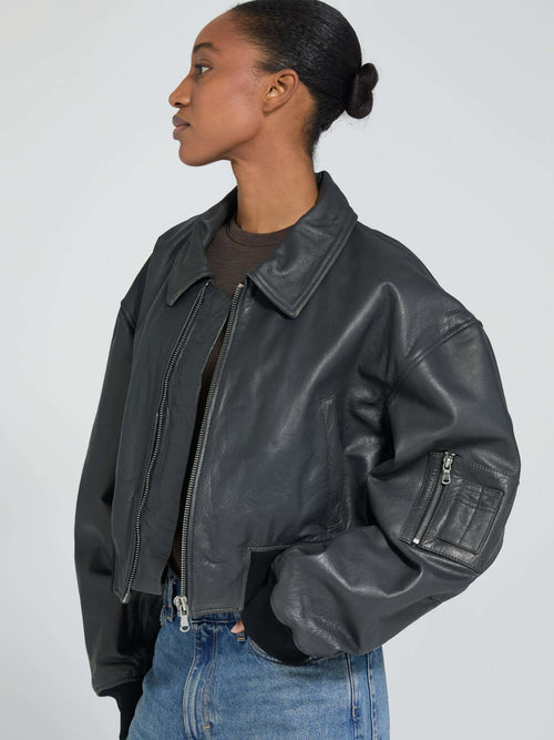 Stylish black leather cropped jacket with a zip closure and oversized fit, perfect for a trendy look by MEOTINE.