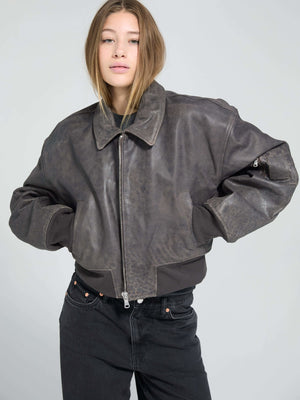 Stylish cropped leather jacket in dark brown, featuring a zip closure and relaxed fit, perfect for a trendy look by MEOTINE.