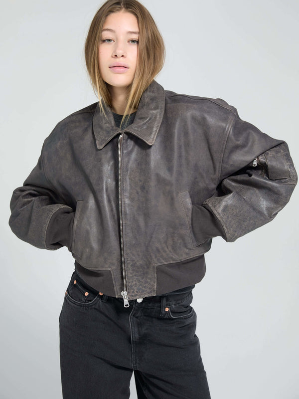 Stylish cropped leather jacket in dark brown, featuring a zip closure and relaxed fit, perfect for a trendy look by MEOTINE.