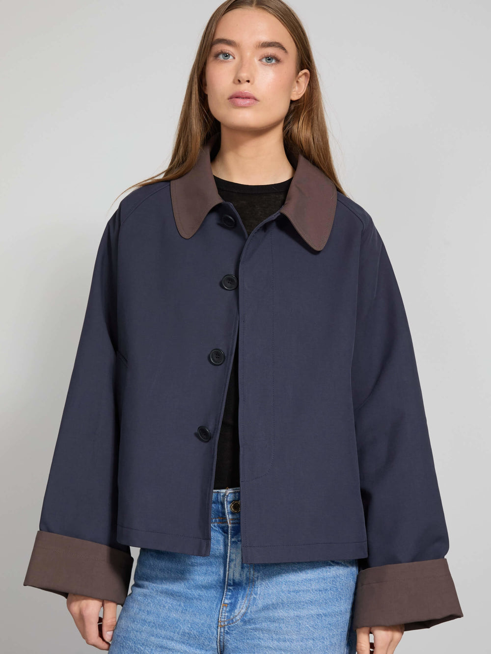 Stylish navy jacket with brown cuffs and collar, perfect for a modern look. Designed by MEOTINE for a chic, casual outfit.
