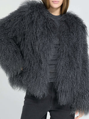 A model showcases a fluffy, dark gray MEOTINE jacket with a cozy, oversized fit, paired with black jeans for a stylish look.