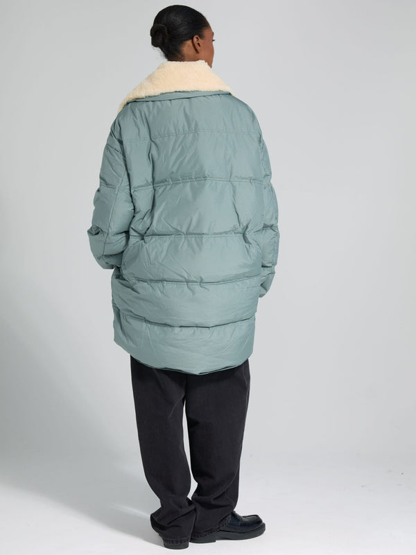 Cozy MEOTINE oversized puffer jacket in soft green with a plush cream collar, perfect for stylish warmth this season.