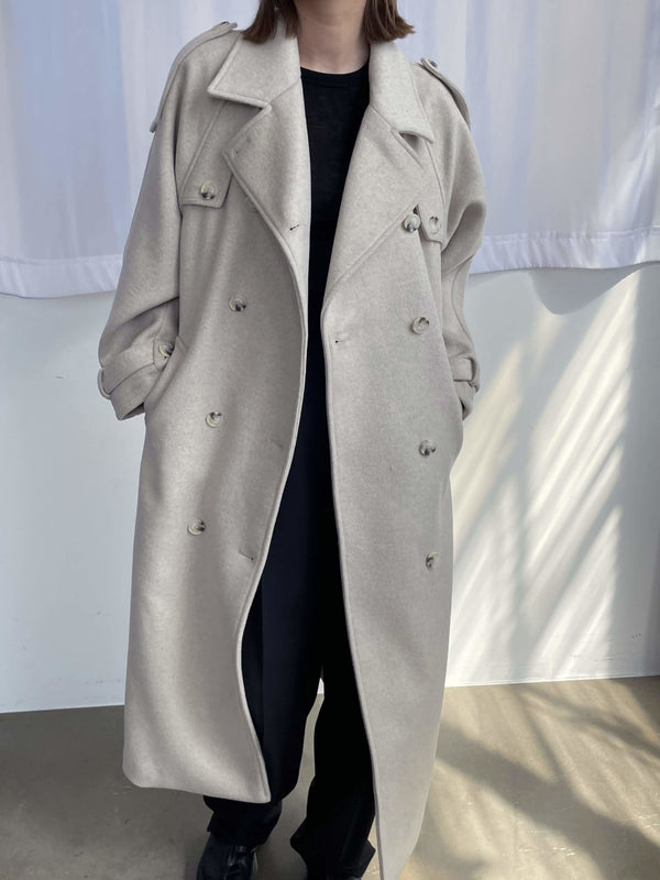A stylish oversized beige trench coat with a double-breasted design, perfect for layering, by MEOTINE.