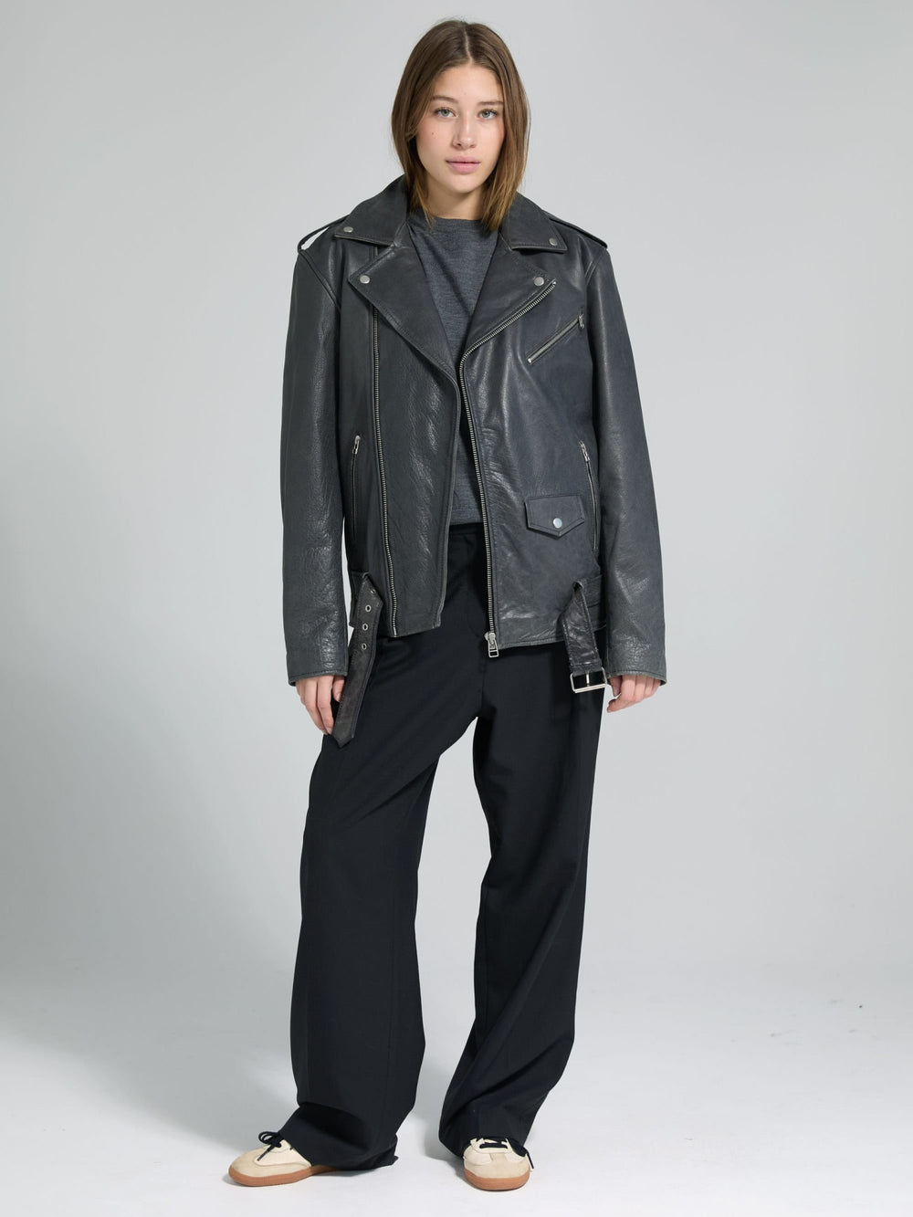 Stylish black leather jacket with a classic biker design, worn by a model, showcasing MEOTINE's edgy fashion aesthetic.