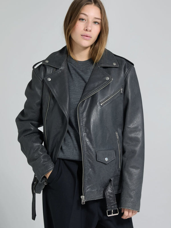 Stylish black leather jacket with a classic biker design, worn by a model, showcasing MEOTINE's edgy fashion aesthetic.