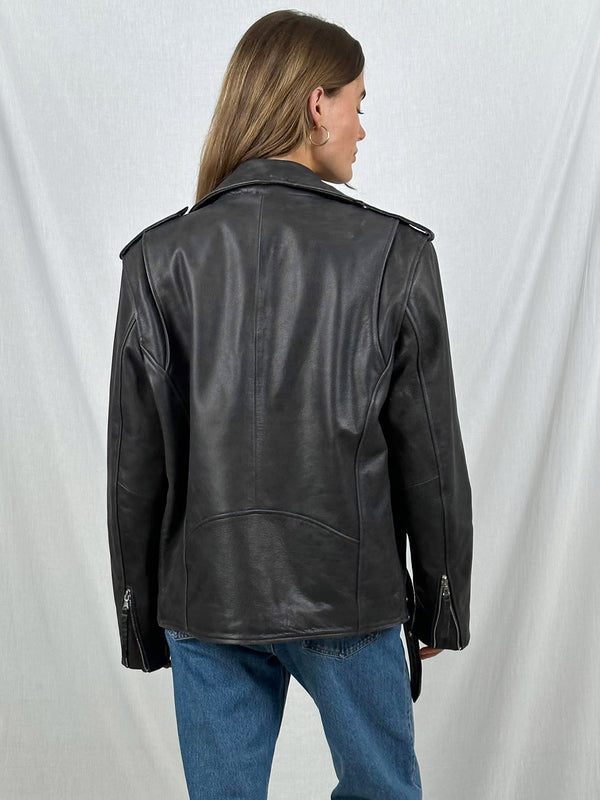 Stylish black leather jacket with a classic design, featuring shoulder epaulets and zippered cuffs, perfect for a trendy look by MEOTINE.