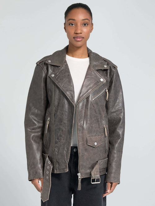 Stylish brown leather jacket with a classic biker design, featuring zippers and a belted waist, by MEOTINE.