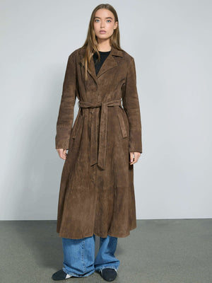 A model wears a long brown suede coat with a belt, paired with wide-leg jeans, showcasing MEOTINE's stylish outerwear.