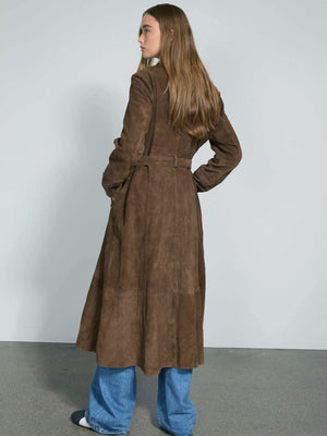 A model showcases a long brown suede coat with a belted waist, paired with wide-leg jeans, embodying MEOTINE's chic style.