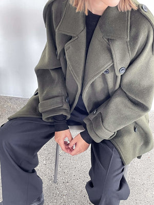 Oversized olive green coat with a stylish collar, paired with black pants, showcasing a modern, chic look by MEOTINE.