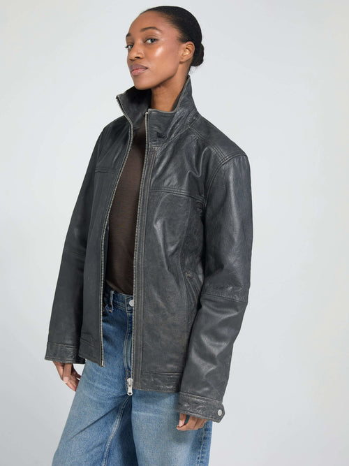 Stylish black leather jacket from MEOTINE, featuring a high collar and a relaxed fit, perfect for a chic, modern look.