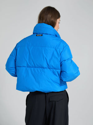 A woman wearing a vibrant blue puffer jacket from MEOTINE, showcasing a stylish back view against a neutral background.