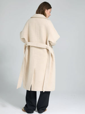 Cozy beige wrap coat with a belt, featuring a relaxed fit and wide sleeves, perfect for layering. By MEOTINE.