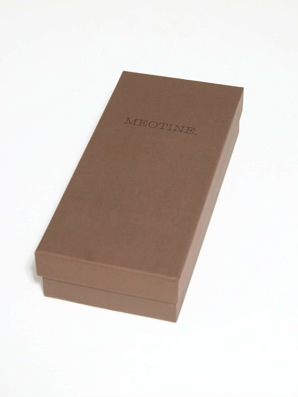 A sleek brown box with the brand name "MEOTINE" elegantly embossed on the top, perfect for gift-giving or storage.