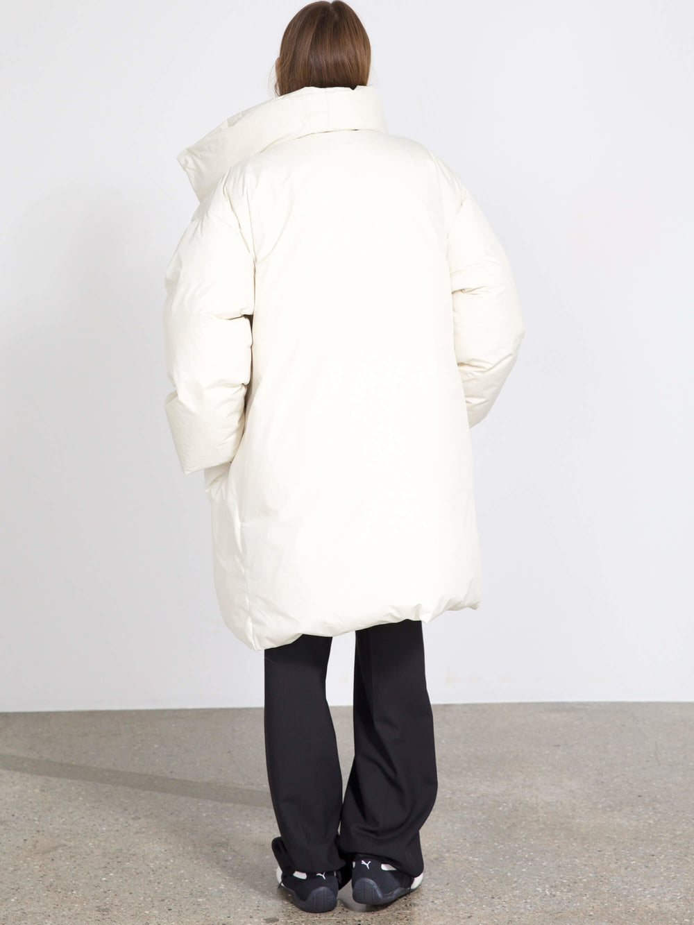 Oversized white puffer coat with a dramatic collar, featuring snap buttons, perfect for a stylish winter look by MEOTINE.