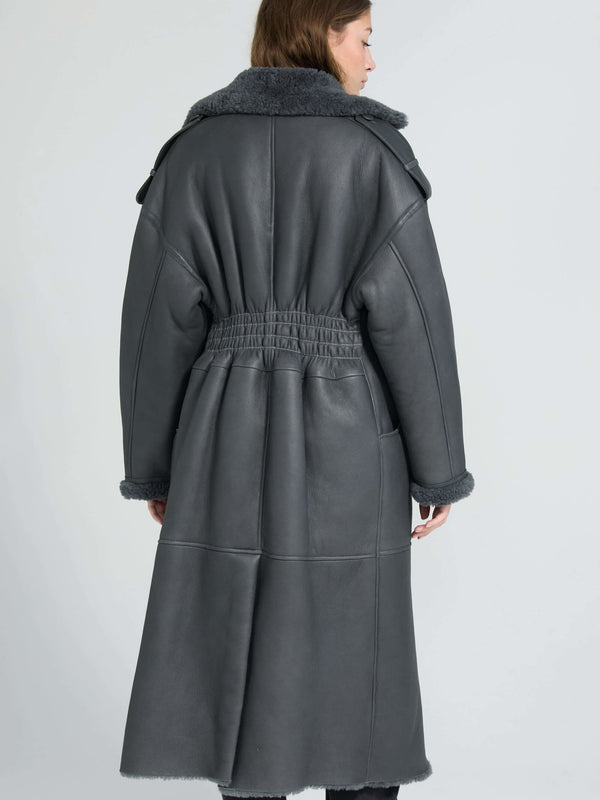 Stylish gray leather coat with a belted waist and soft fur collar, perfect for a chic winter look by MEOTINE.