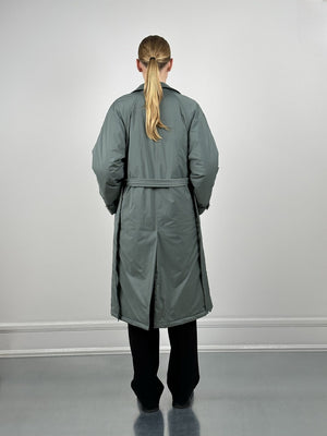 A model wearing a long, oversized gray coat from MEOTINE, viewed from the back, styled with black pants.