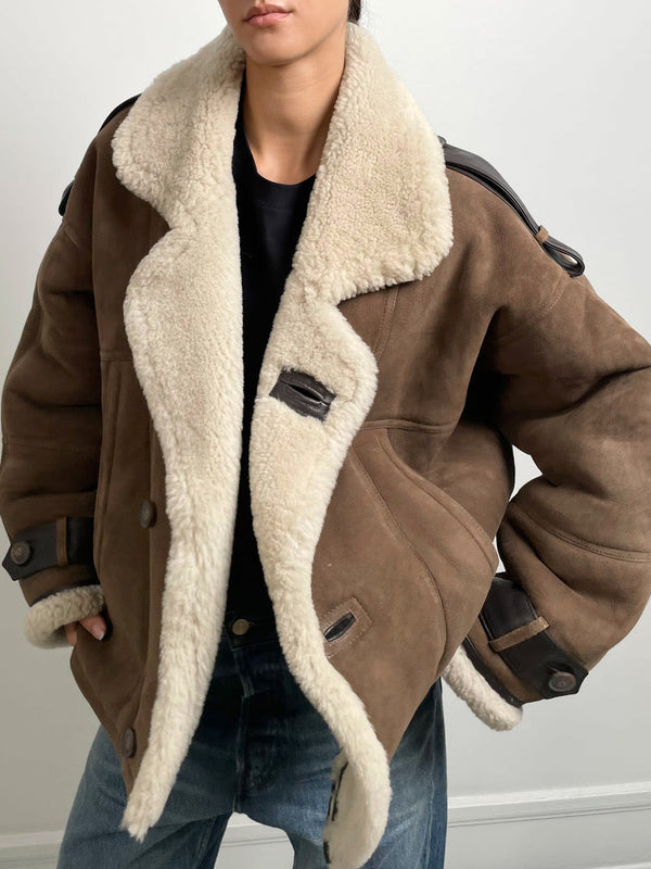 Cozy brown shearling jacket with a plush collar, featuring a relaxed fit and stylish details, perfect for a chic look by MEOTINE.