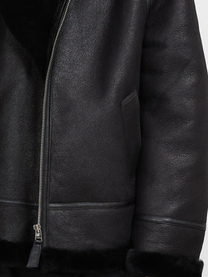 Black leather jacket with a soft shearling lining, featuring a zip closure and side pockets, by MEOTINE.