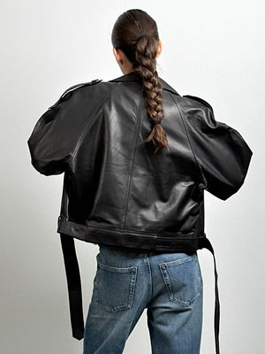 Stylish black leather jacket with a relaxed fit, paired with high-waisted jeans, showcasing a modern look by MEOTINE.