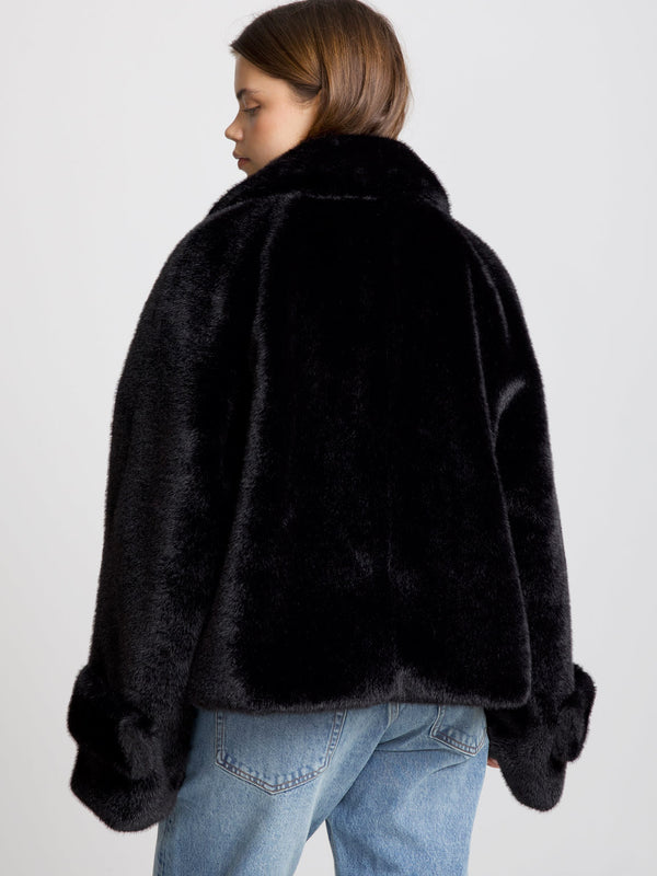 Cozy black faux fur jacket with a relaxed fit and oversized sleeves, perfect for stylish warmth this season by MEOTINE.