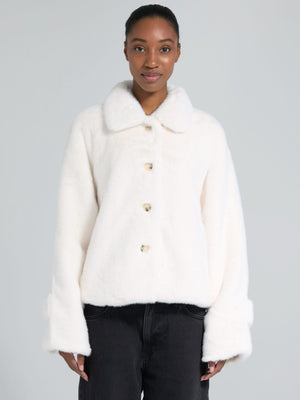 Cozy white faux fur jacket with a collar and button closure, perfect for stylish warmth. From MEOTINE's latest collection.