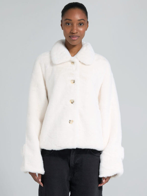 Cozy white faux fur jacket with a collar and button closure, perfect for stylish warmth. From MEOTINE's latest collection.