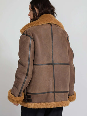 Brown shearling jacket with a cozy tan collar and cuffs, featuring a stylish panel design. Perfect for winter warmth by MEOTINE.