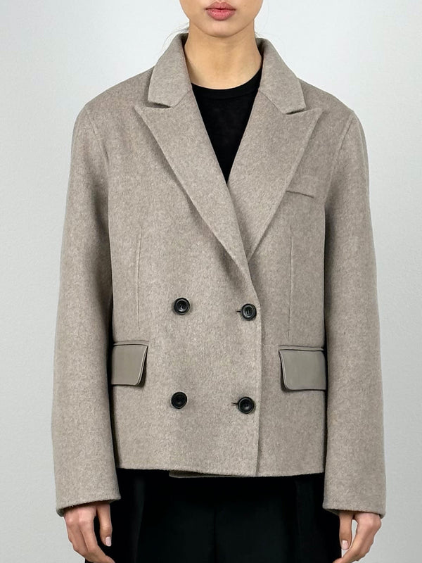 Stylish beige double-breasted coat with black buttons and sleek pockets, perfect for a chic look by MEOTINE.