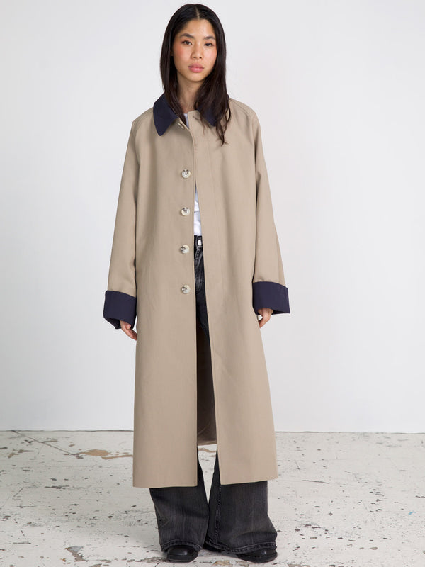 A stylish beige long coat with a navy collar and cuffs, perfect for a chic look. Designed by MEOTINE for modern elegance.