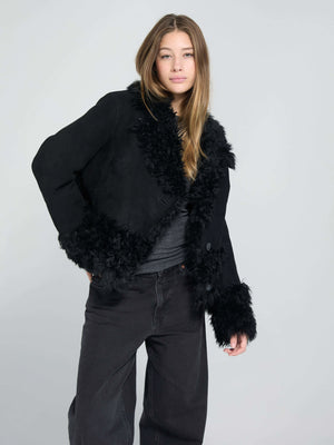Stylish black jacket with fluffy trim, featuring a chic design perfect for a trendy look. By MEOTINE.