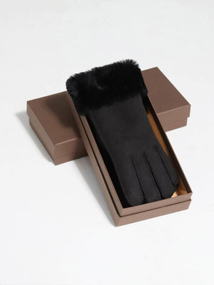 Elegant black gloves with a soft fur cuff, presented in a stylish brown box, perfect for winter fashion by MEOTINE.
