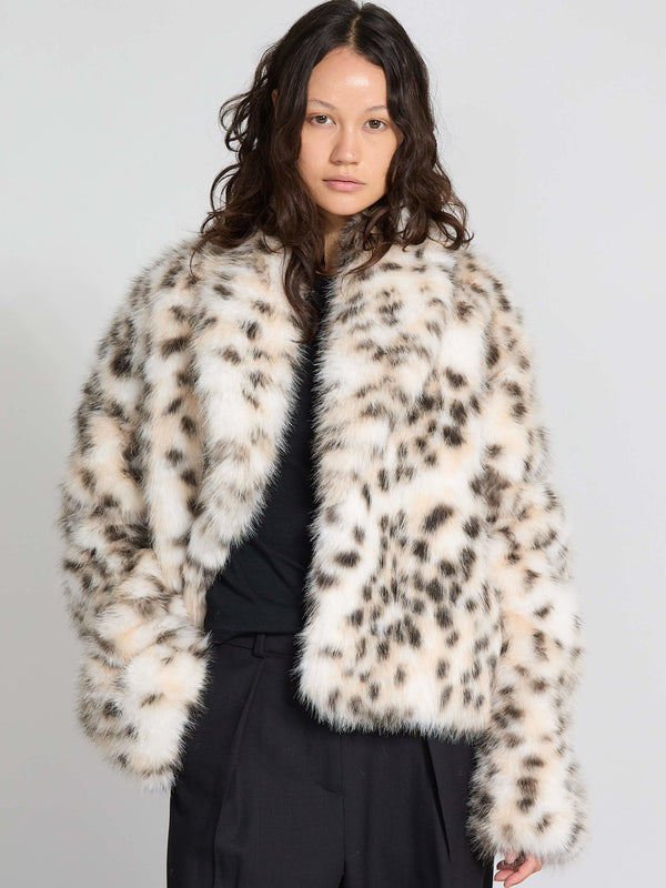 A model showcases a stylish MEOTINE faux fur coat with a leopard print design, featuring a cozy, oversized fit.