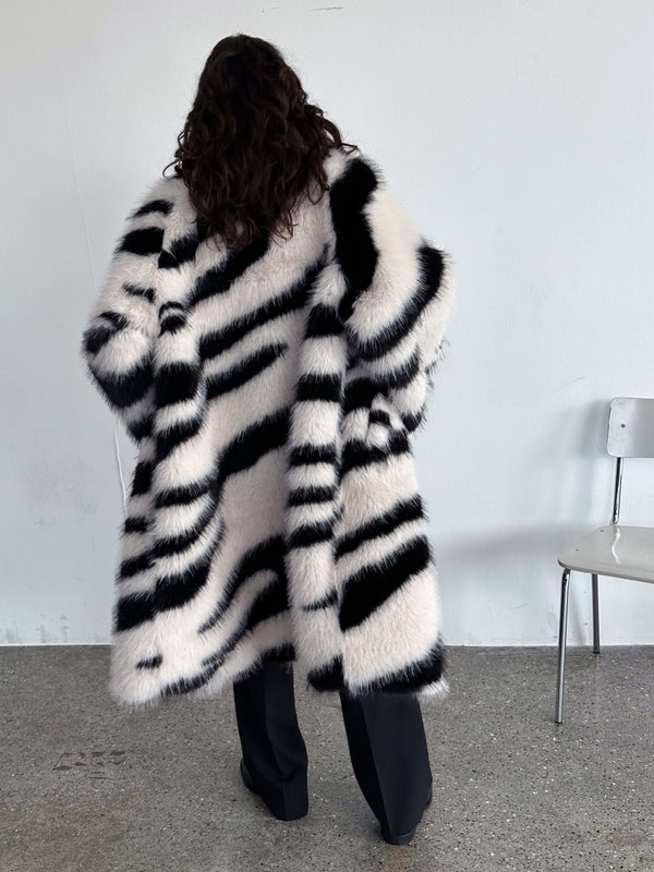 Stylish black and white striped faux fur coat by MEOTINE, featuring a cozy oversized fit and elegant design.