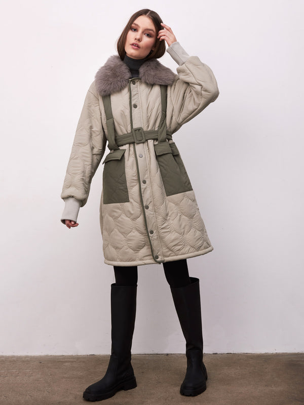 Stylish MEOTINE quilted coat with a fur collar, belted waist, and contrasting green pockets, perfect for winter fashion.