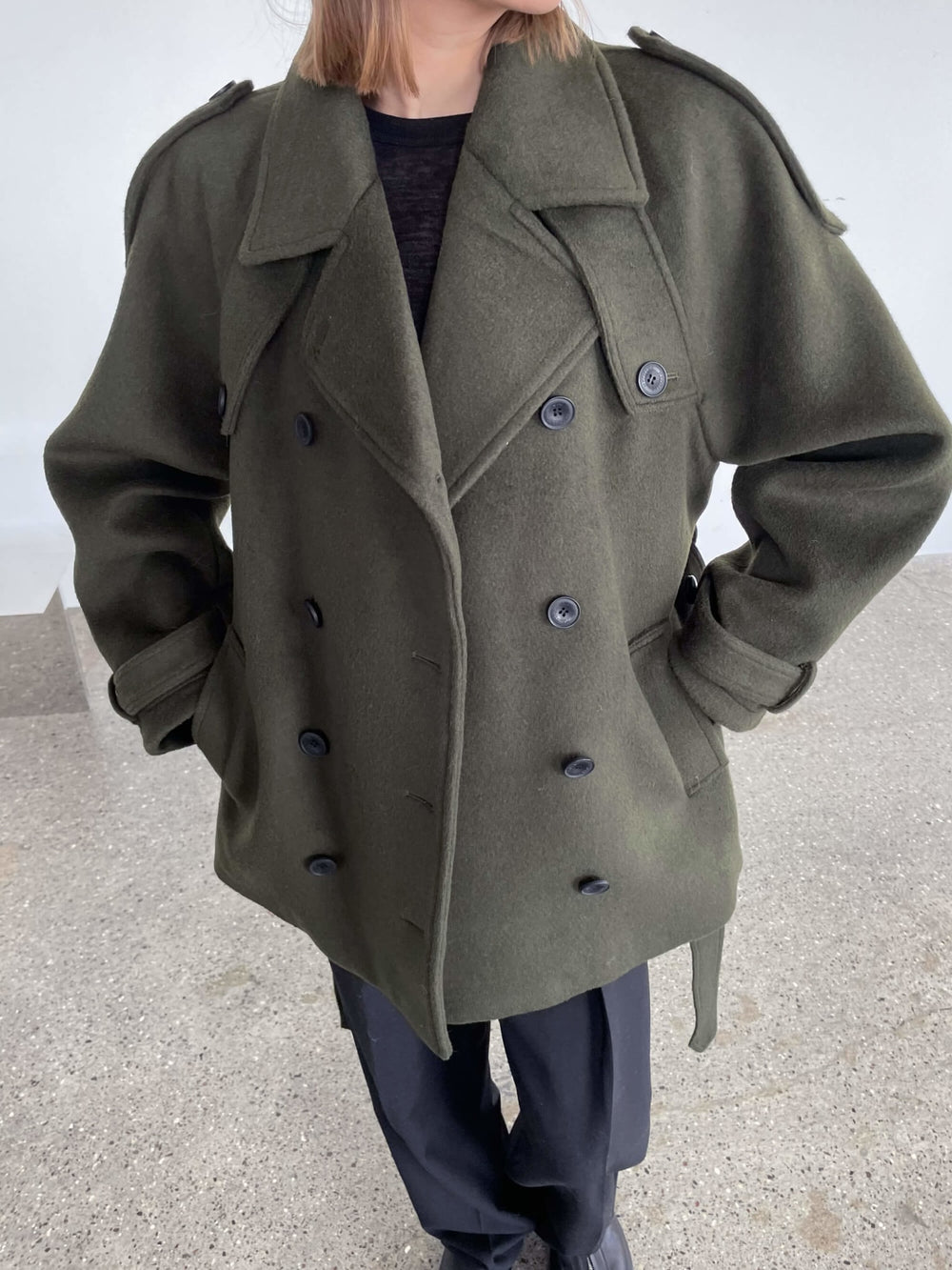 A model wears a stylish oversized green coat with a double-breasted design, showcasing MEOTINE's unique fashion aesthetic.