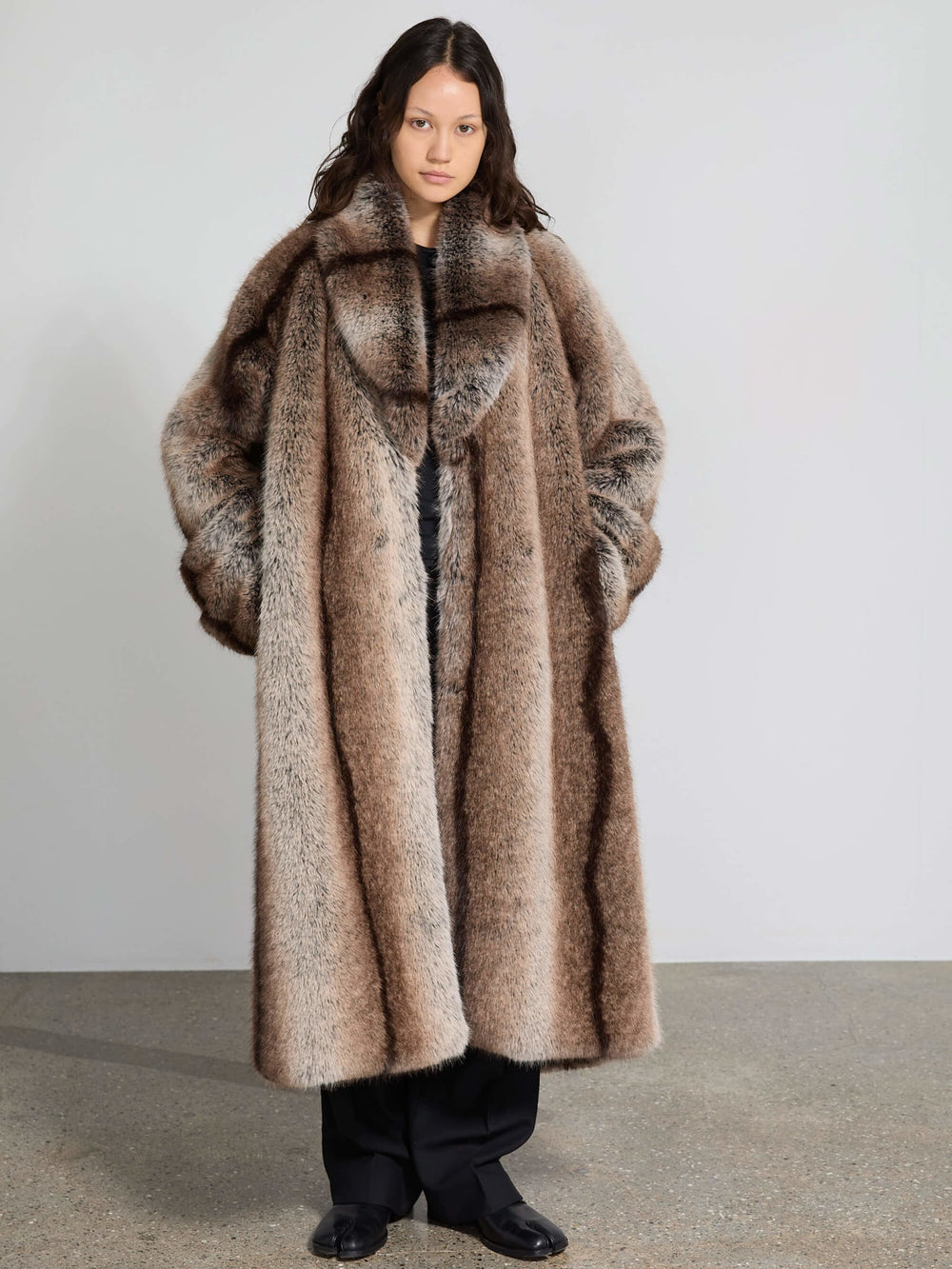Luxurious oversized faux fur coat in soft brown tones, featuring a wide collar and relaxed fit, perfect for stylish warmth by MEOTINE.