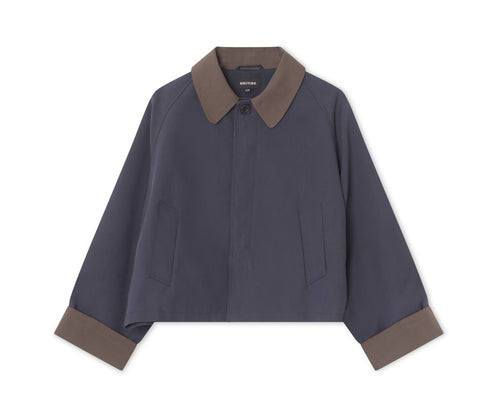 Stylish cropped jacket in navy with a contrasting brown collar and cuffs, perfect for a modern look. By MEOTINE.