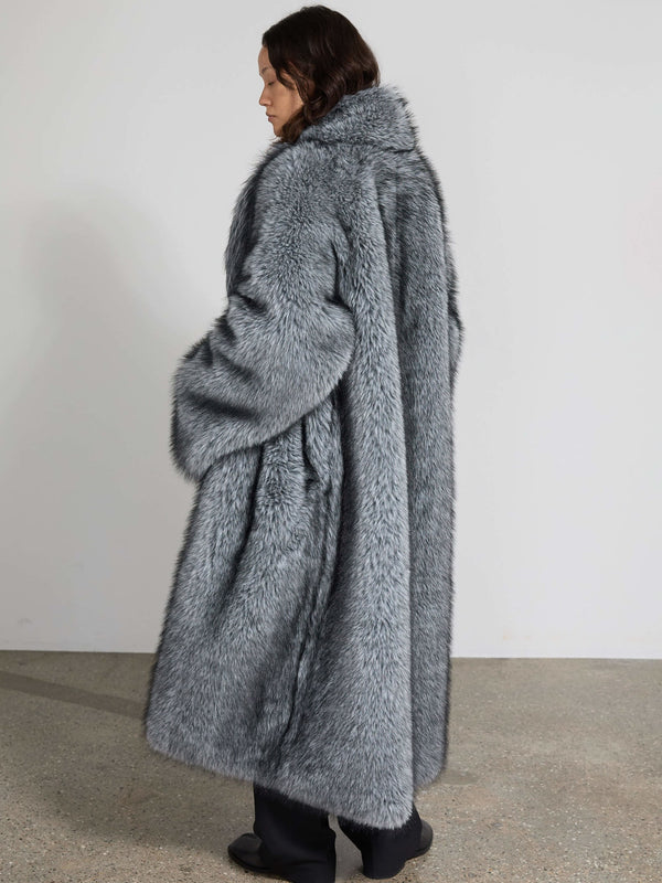 A model wearing a luxurious gray faux fur coat from MEOTINE, showcasing a cozy and stylish design from the back.