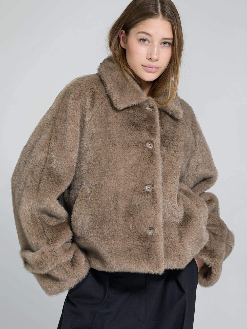 A model wears a cozy, oversized brown faux fur jacket with a collar and button closure, showcasing MEOTINE's stylish design.