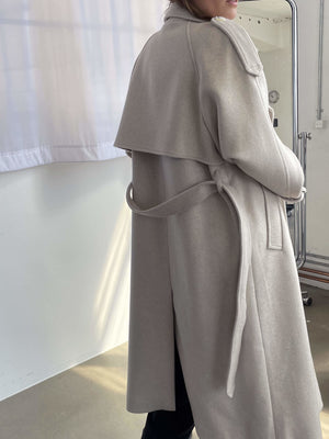 A stylish beige coat with a belted waist and a draped collar, perfect for a chic look by MEOTINE.