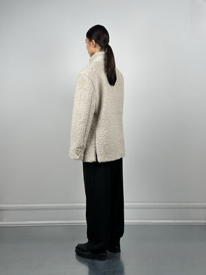 Cozy cream-colored fleece jacket from MEOTINE, featuring a relaxed fit and a high collar, styled with loose black pants.