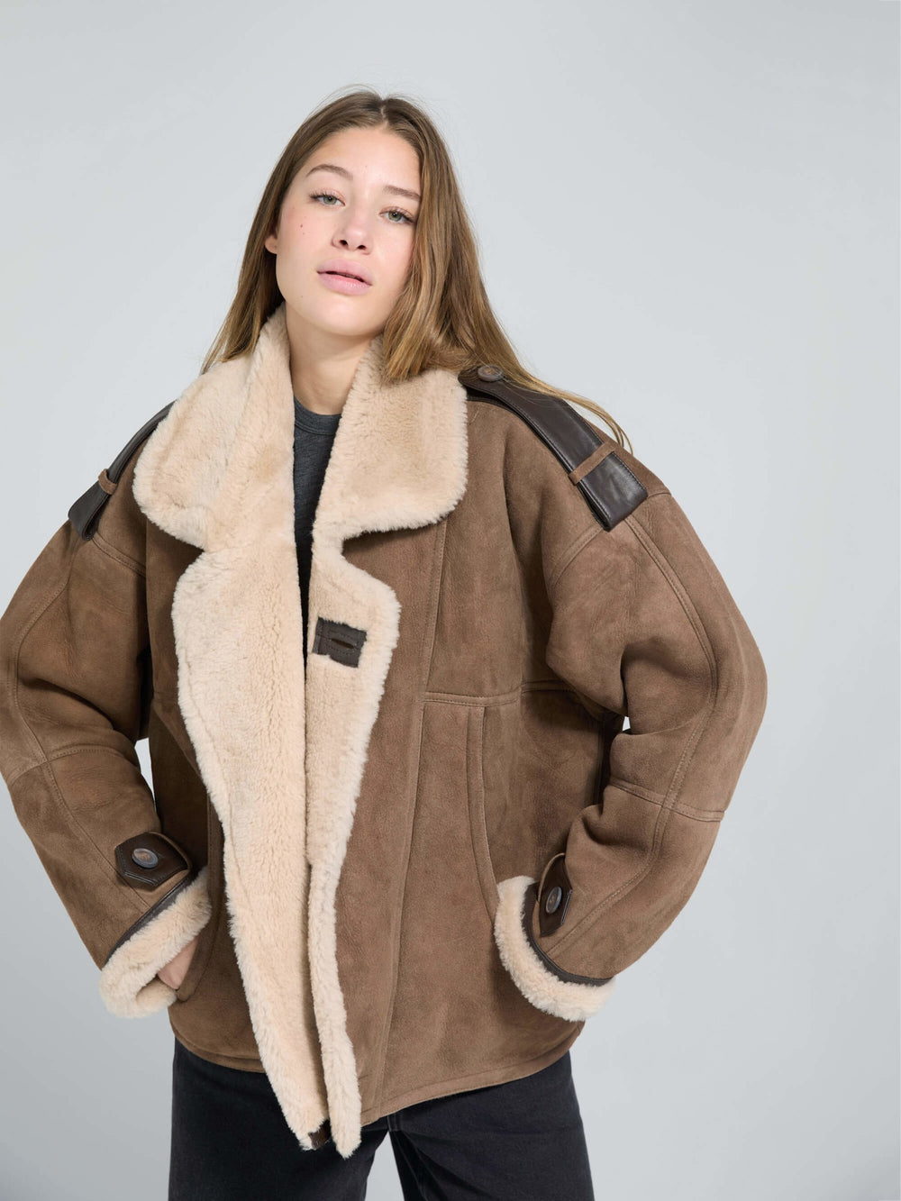 Cozy brown shearling jacket with a plush collar and leather accents, perfect for stylish warmth this season by MEOTINE.