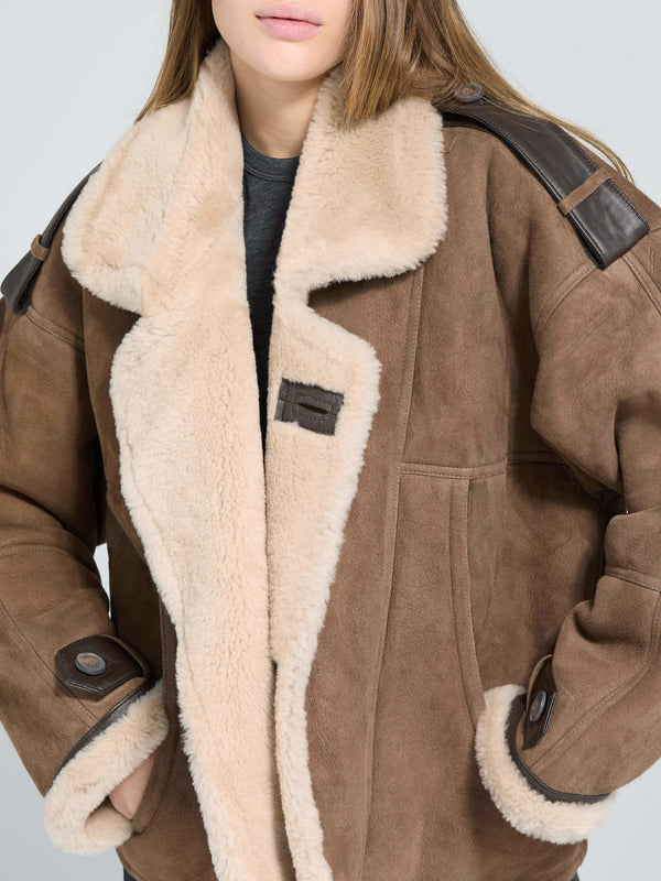 Cozy brown shearling jacket with a plush beige lining and leather accents, perfect for stylish warmth by MEOTINE.